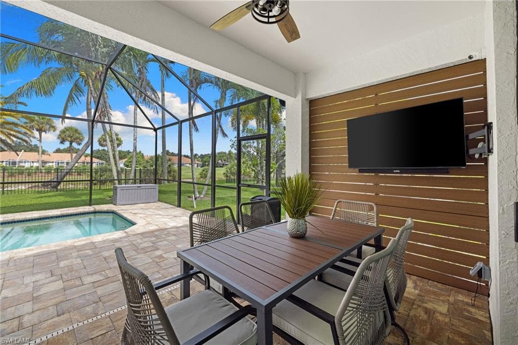 Screened patio with a built-in pool, paver flooring, and a decorative slatted wood accent wall