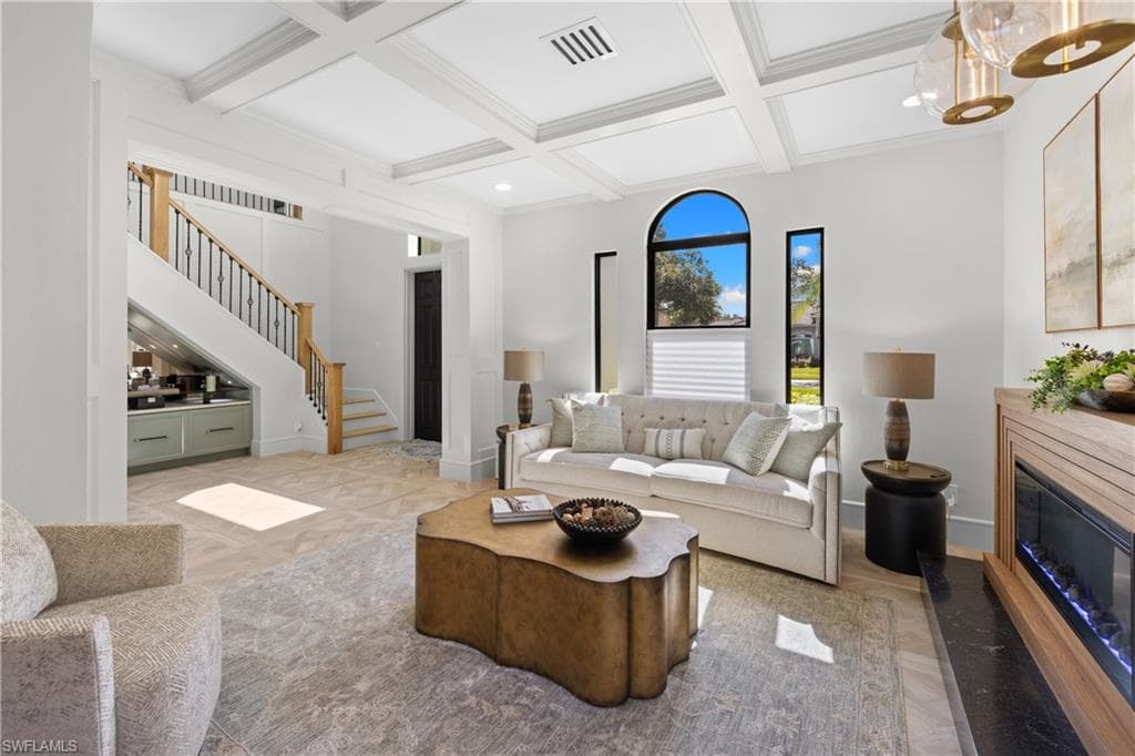 Living area featuring large format tile flooring, a ceiling fan with integrated lighting, and expansive sliding glass doors