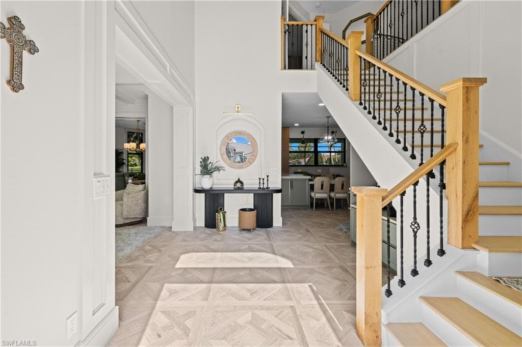 Gourmet kitchen featuring a white range, custom wood cabinetry, light countertops, wood-finish flooring, and a patterned accent wall