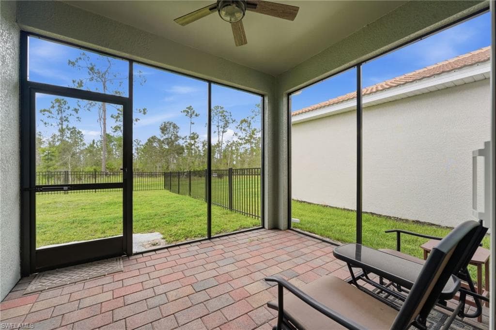 Screened lanai overlooking the fenced in yard.
