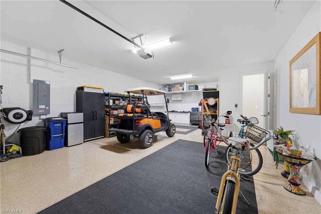 2.5 Car Garage with Epoxy finished floor & built in cabinetry. The golf cart stays with the home.