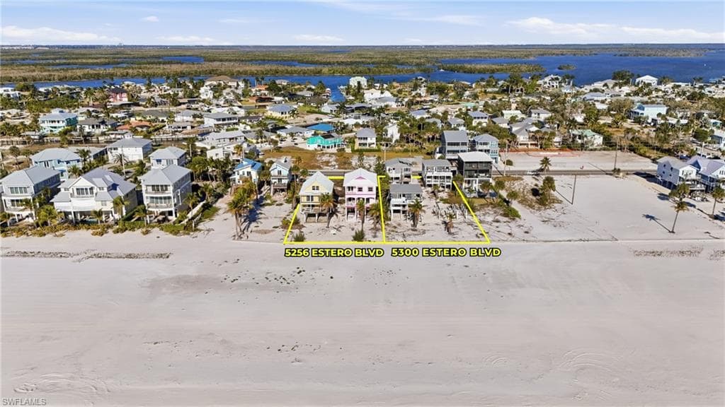 Beachfront properties showcasing direct sandy beach access and a surrounding coastal community