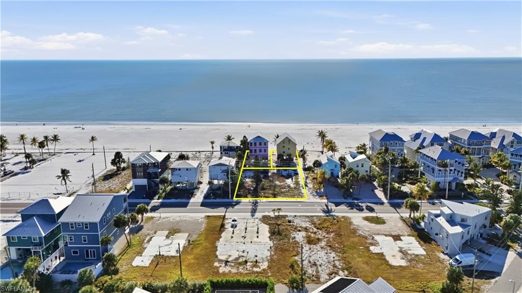 Aerial perspective of suburban area featuring expansive beach