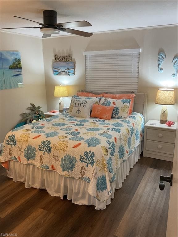 Bedroom featuring wood-finish flooring, a ceiling fan with integrated lighting, and a window with horizontal blinds