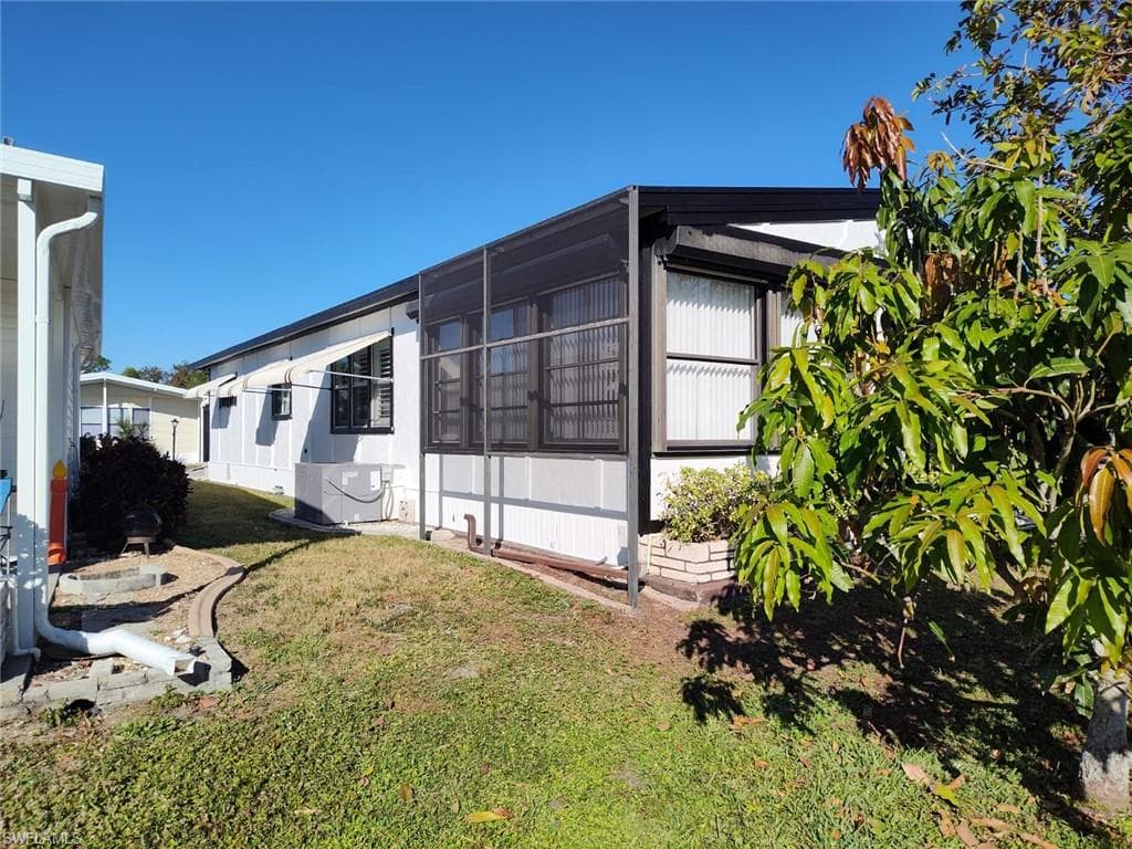 White siding exterior with a black trim roofline