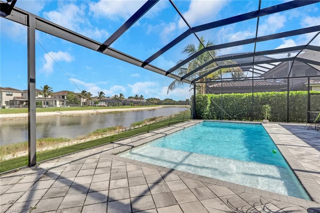 Large, enclosed lanai with heated pool and gorgeous lake view! Great space for entertaining or relaxing by the pool enjoying the lake view.