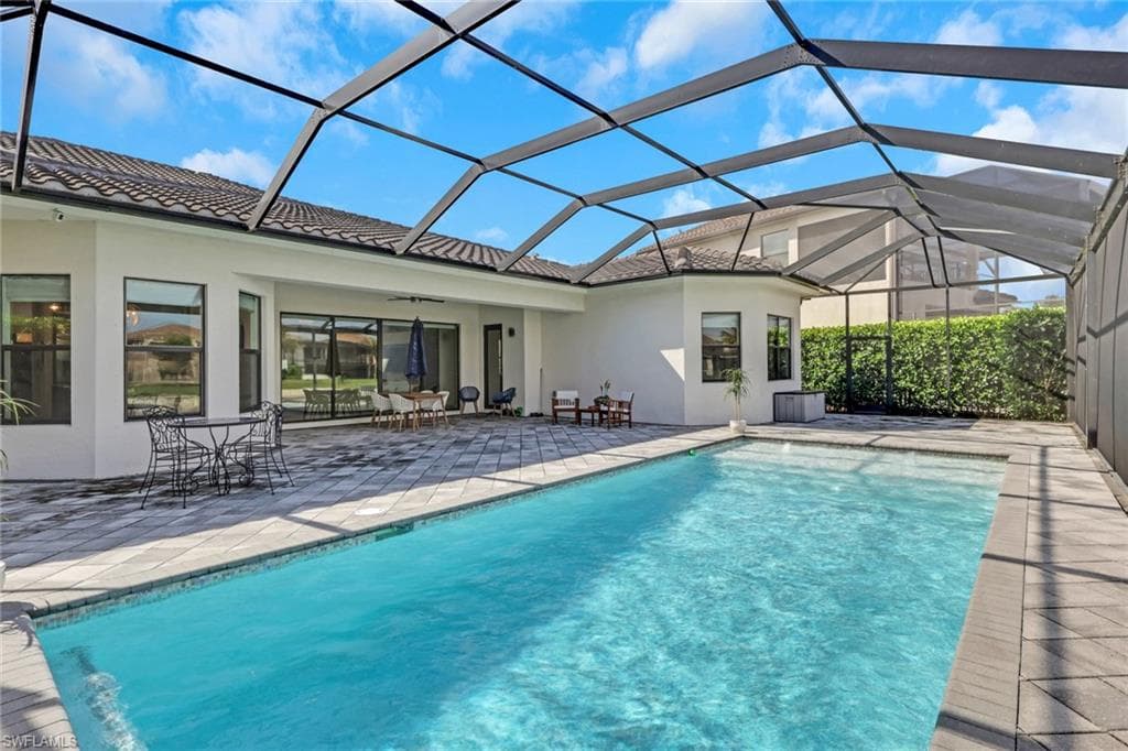 Large, enclosed lanai with heated pool and gorgeous lake view! Great space for entertaining or relaxing by the pool enjoying the lake view.