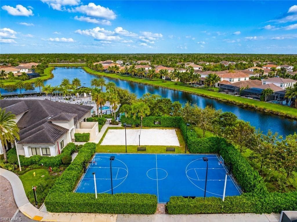 View of outdoor community basketball court and sand volleyball