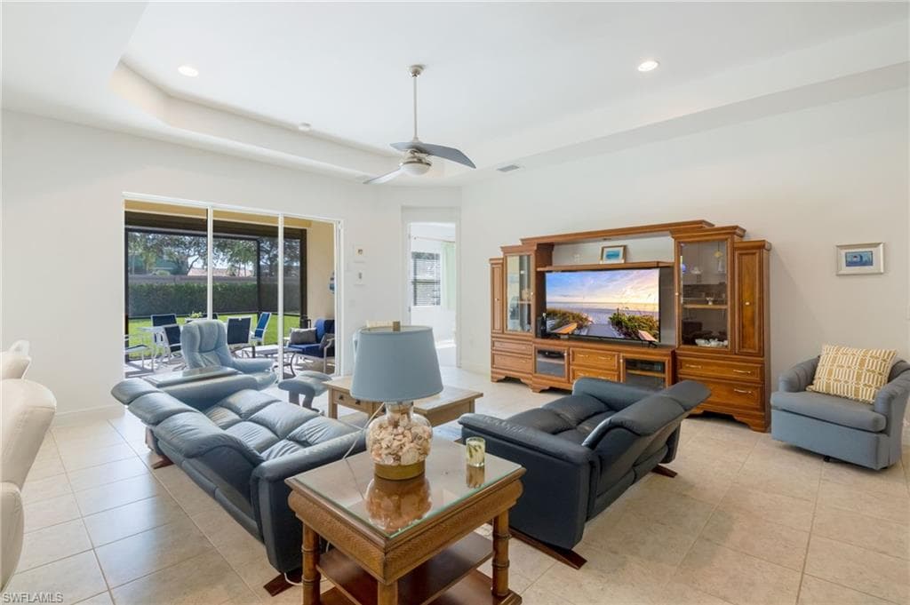 Living area featuring recessed lighting, a ceiling fan, and large tile flooring