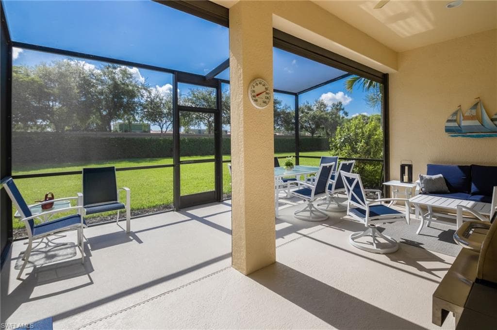 Screened outdoor living area with a textured concrete floor