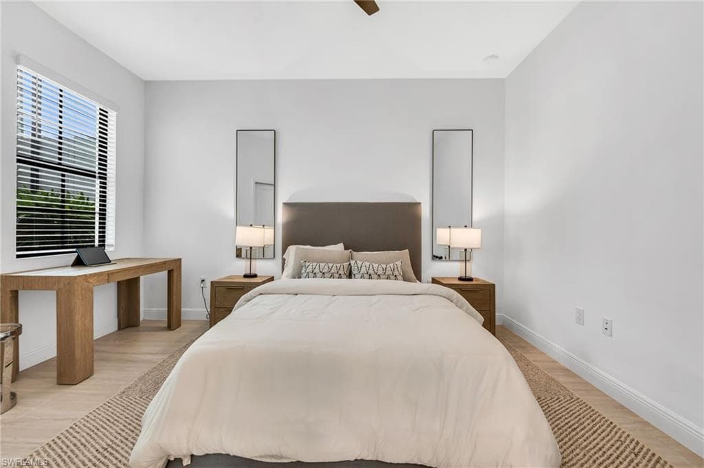 Bright room featuring wood-finish flooring and a ceiling fan