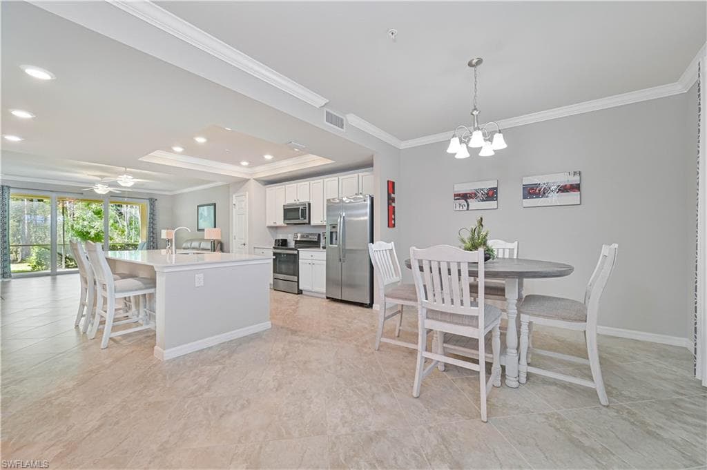 Open-concept dining area seamlessly connected to the kitchen and great room, creating an ideal space for entertaining while enjoying beautiful preserve views.