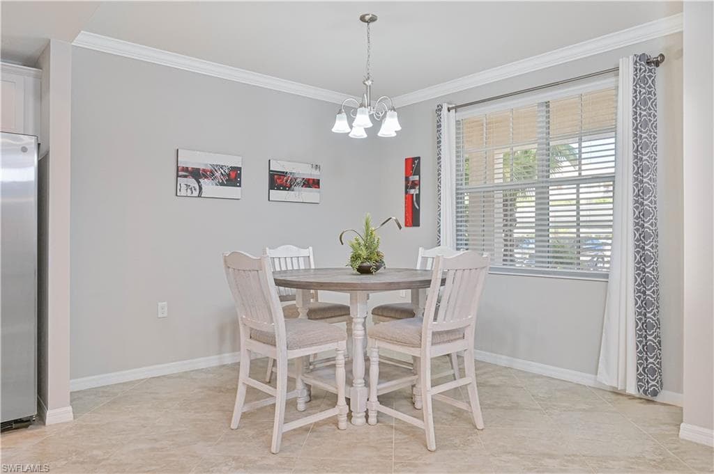 Bright and inviting dining area featuring large windows, abundant natural light, and the perfect setting for casual meals or entertaining guests.