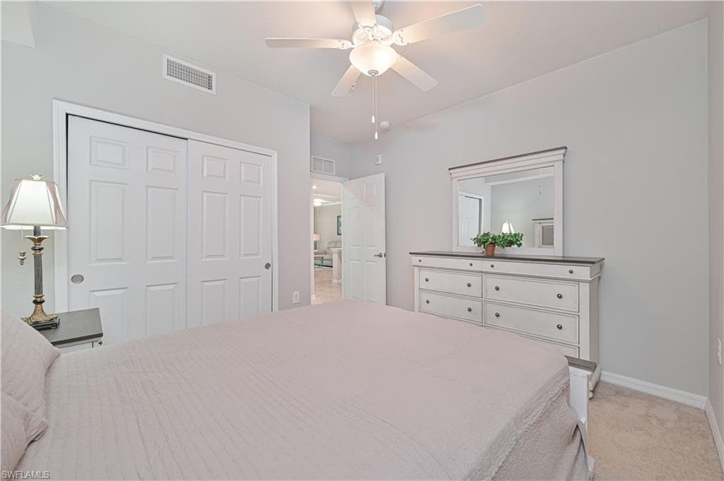 Private guest bedroom located within the home's desirable split-bedroom floor plan, providing comfort and privacy for visitors.