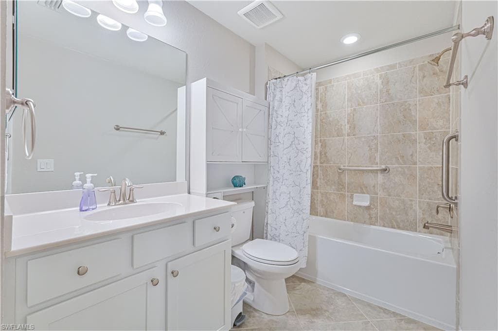 Well-appointed guest bathroom featuring a tiled tub/shower combination, spacious vanity, ample storage, and modern finishes throughout.