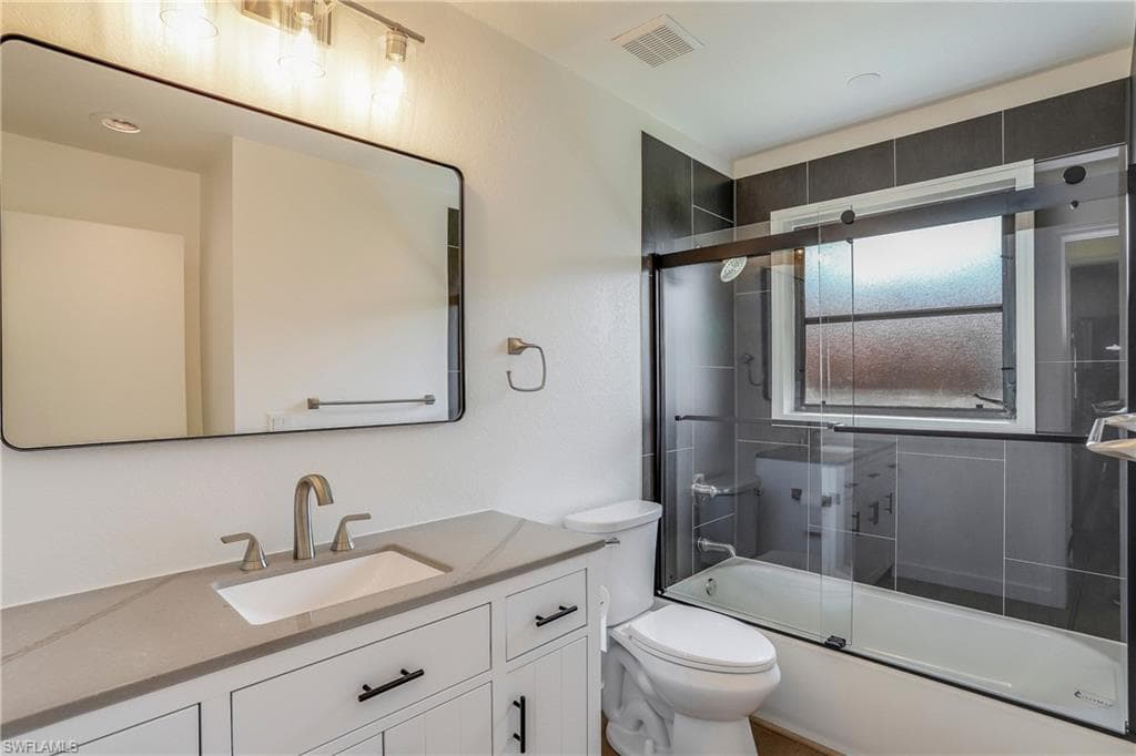 Bathroom featuring a white vanity with a light-toned countertop