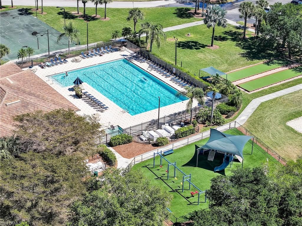 Community amenities featuring a large swimming pool, surrounding lounge area, and adjacent sports courts