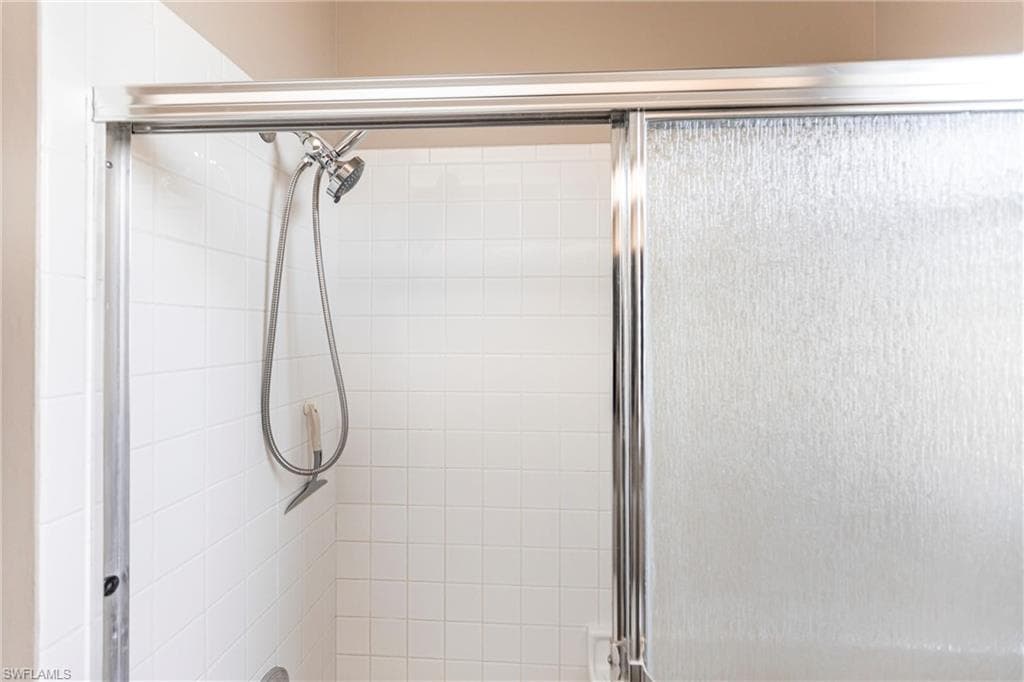 Guest bathroom with tub/shower combo and hurricane rated window.