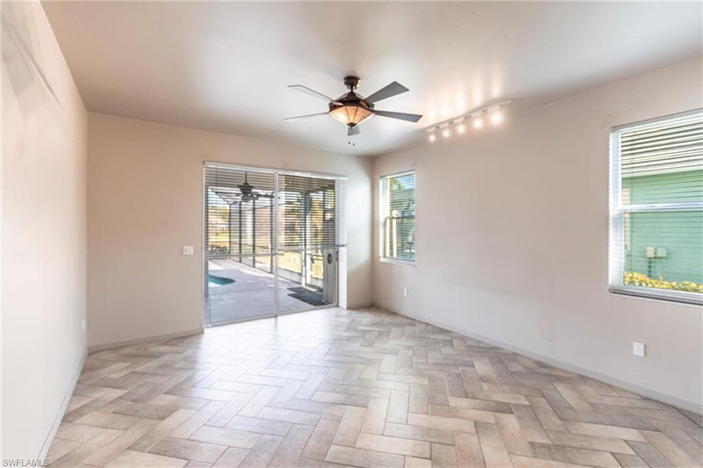 Imported Italian Ceramic tiles and hurricane rated windows, pocket sliders lead to pool, side lanai entry and lake view with beautiful ceiling fan.