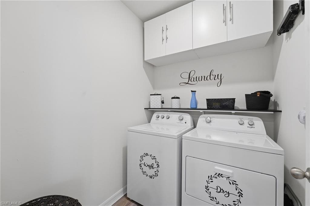 Laundry room with additional cabinetry.