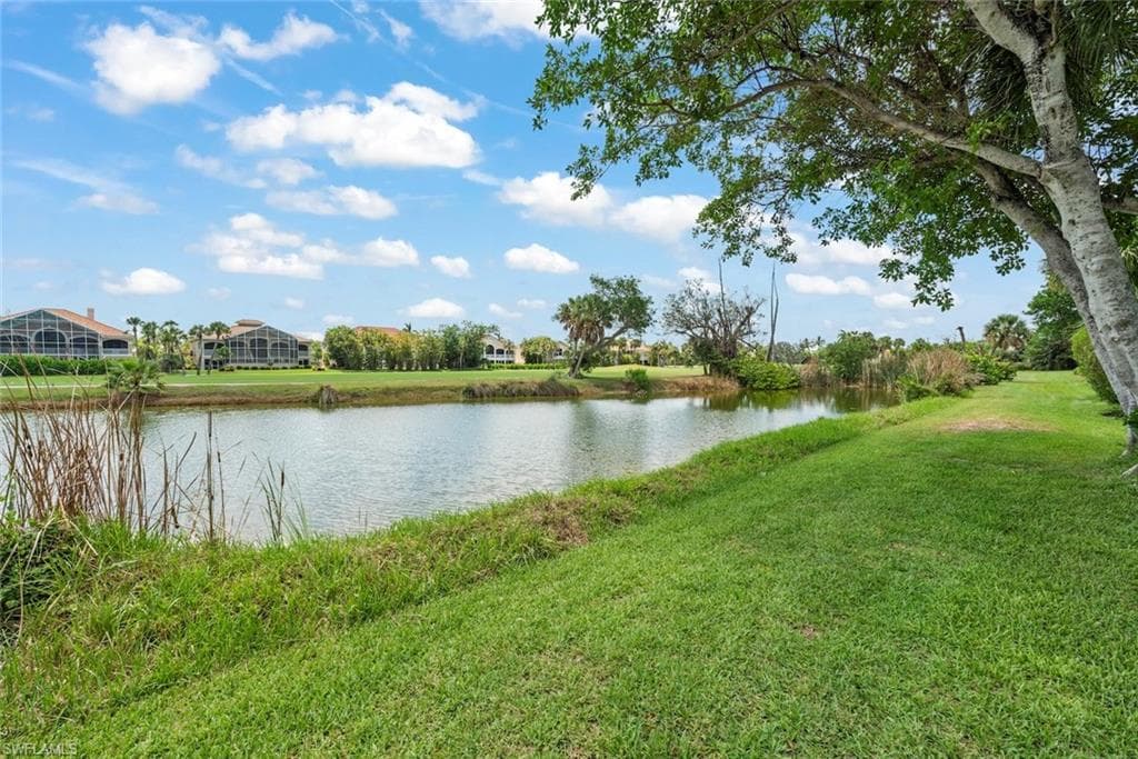 Expansive green space bordering a tranquil water feature