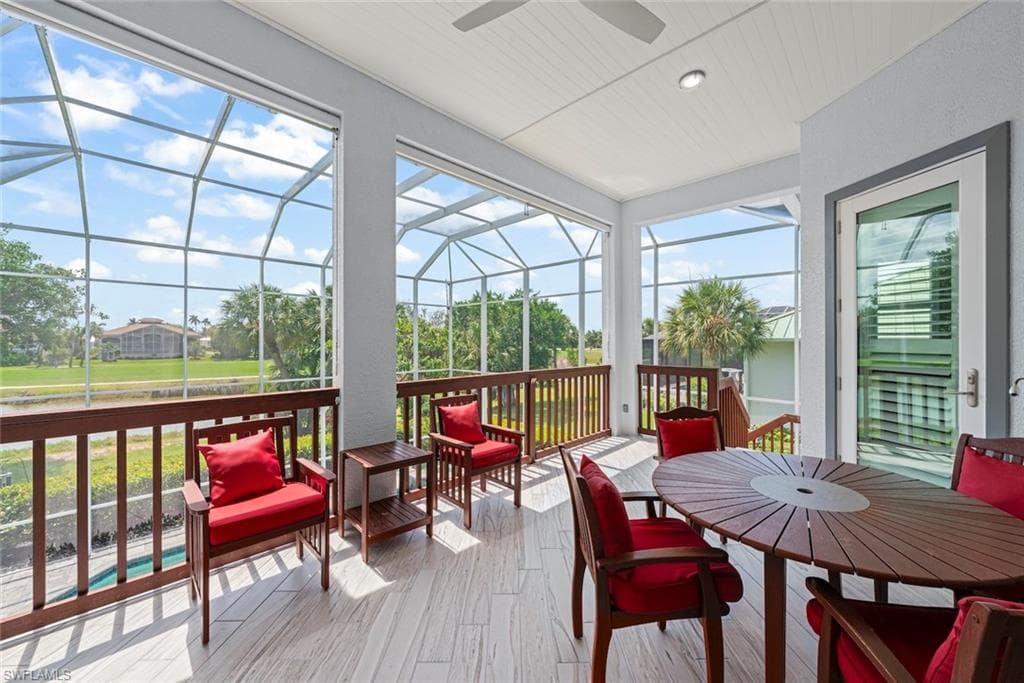 Spacious screened-in lanai with wood-look tile flooring