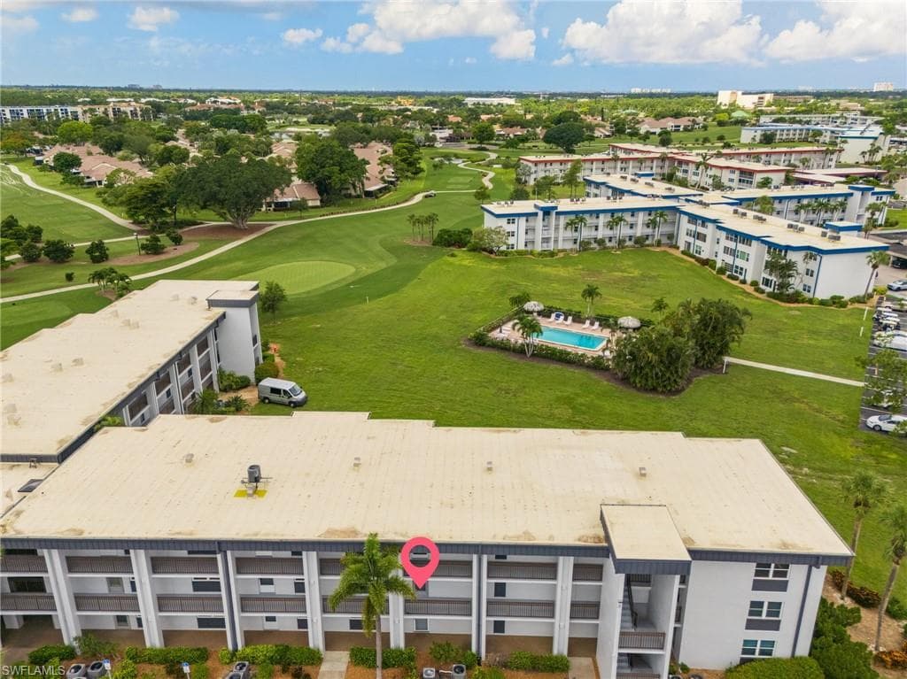 Aerial perspective highlighting multi-story residential buildings with surrounding green spaces
