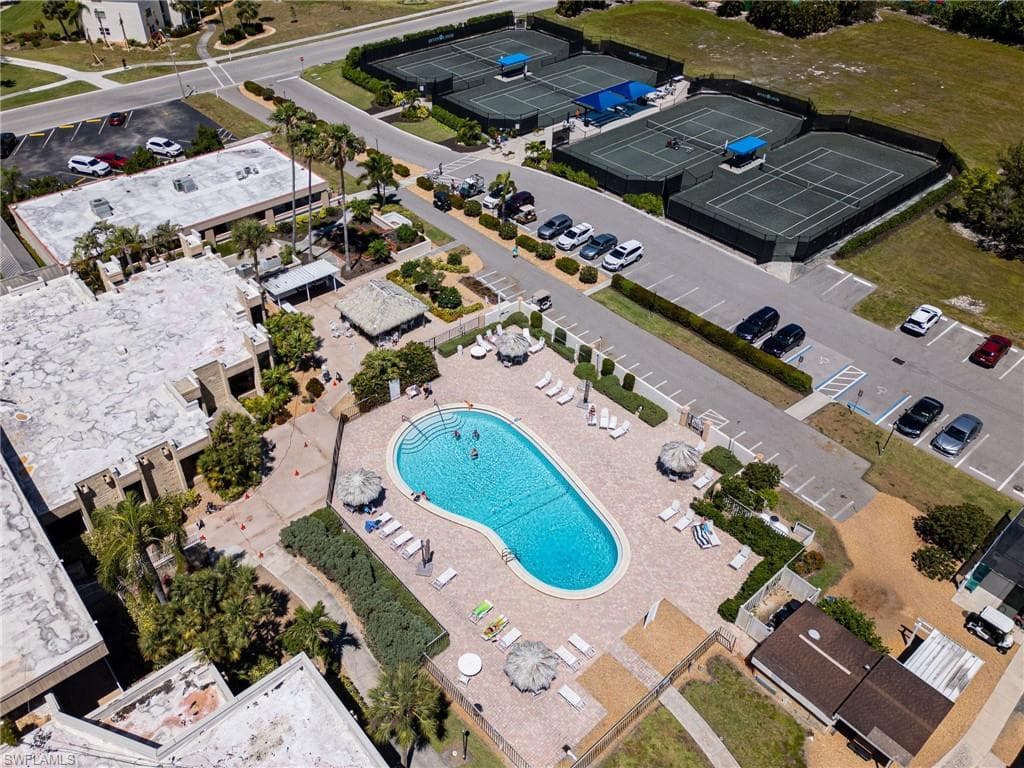 Resort-style pool area with ample lounge seating and shaded cabanas