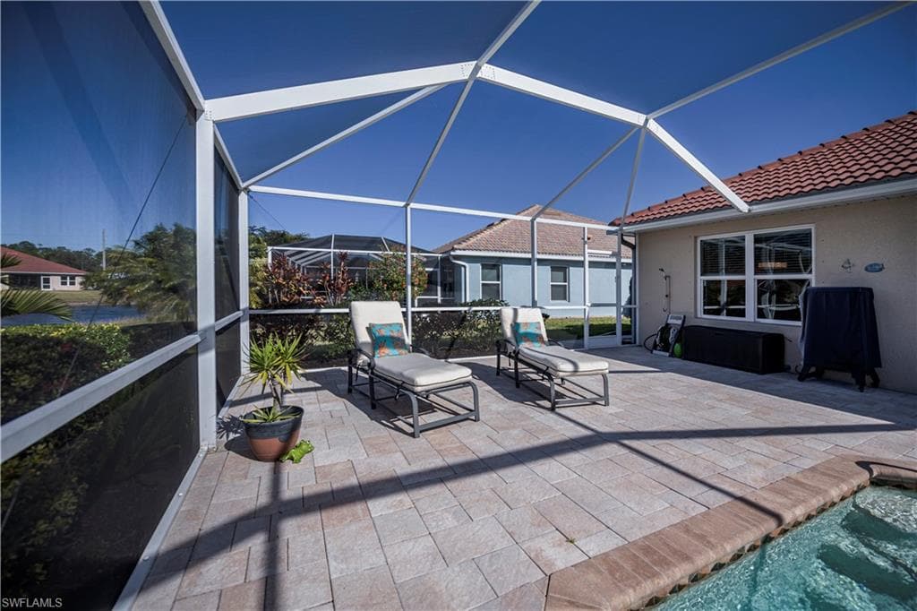 View of patio / terrace featuring a lanai