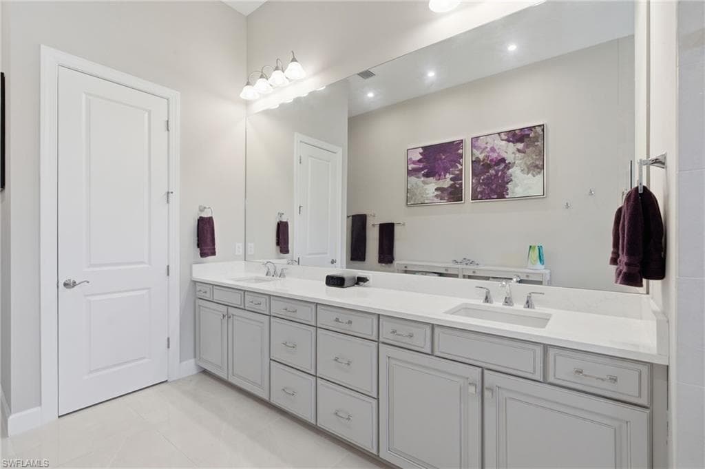 Spacious bathroom featuring a dual vanity with light gray cabinetry and white countertops