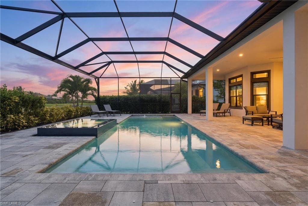 Screened lanai featuring a swimming pool with an integrated spa
