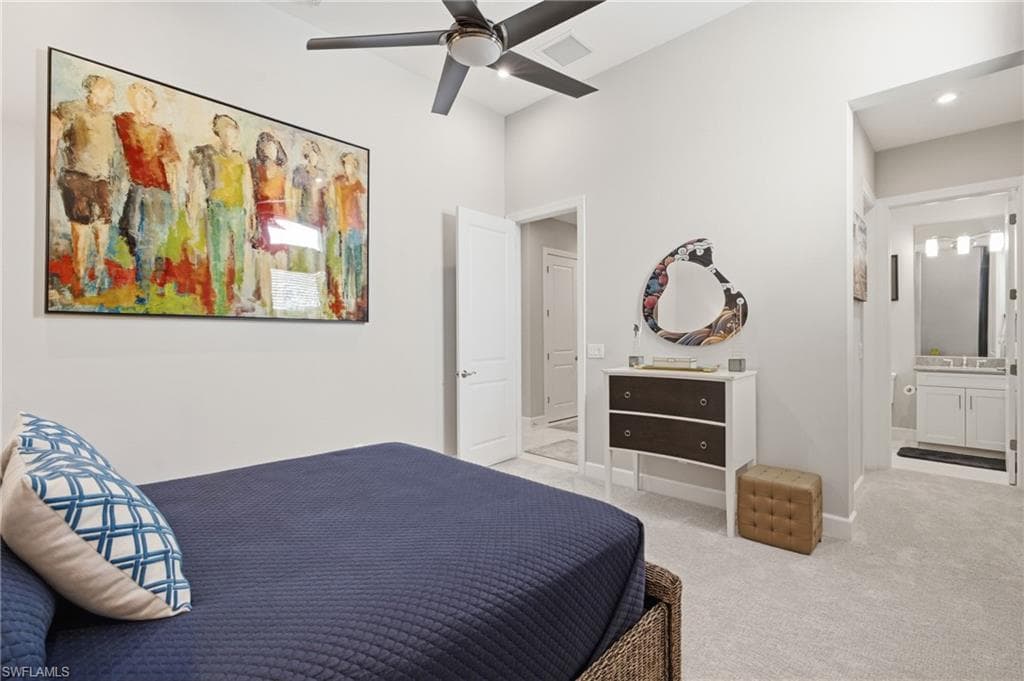 Carpeted room featuring a ceiling fan, white walls, and a recessed doorway