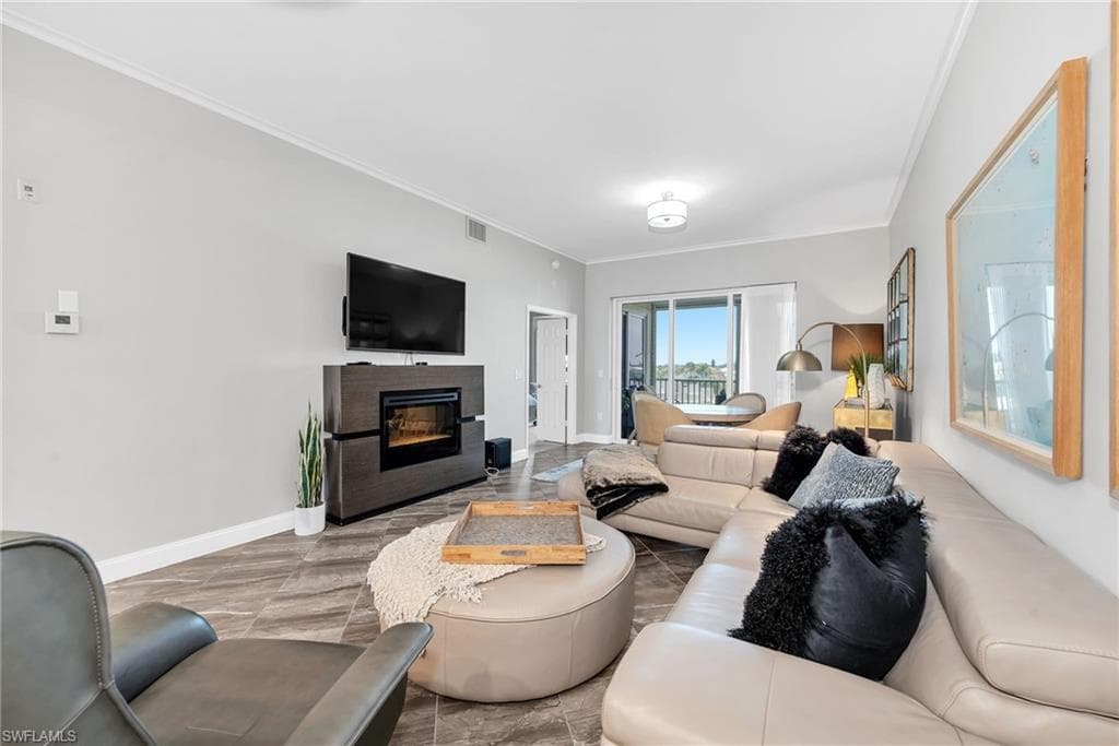 Open living area with wood-finish flooring and a built-in fireplace feature