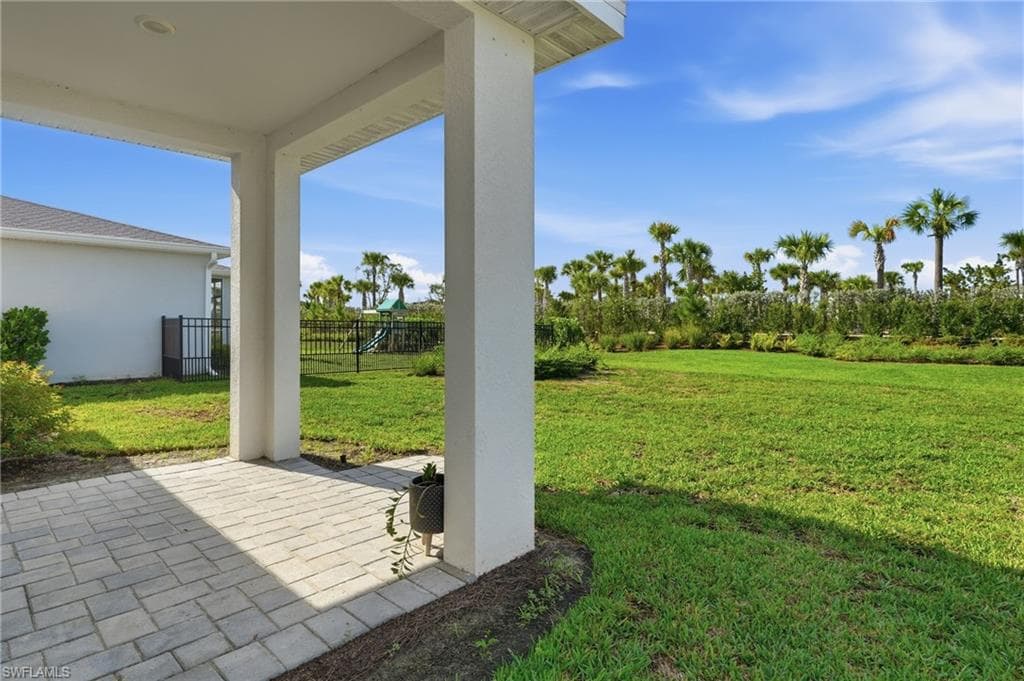Covered outdoor patio featuring paver flooring