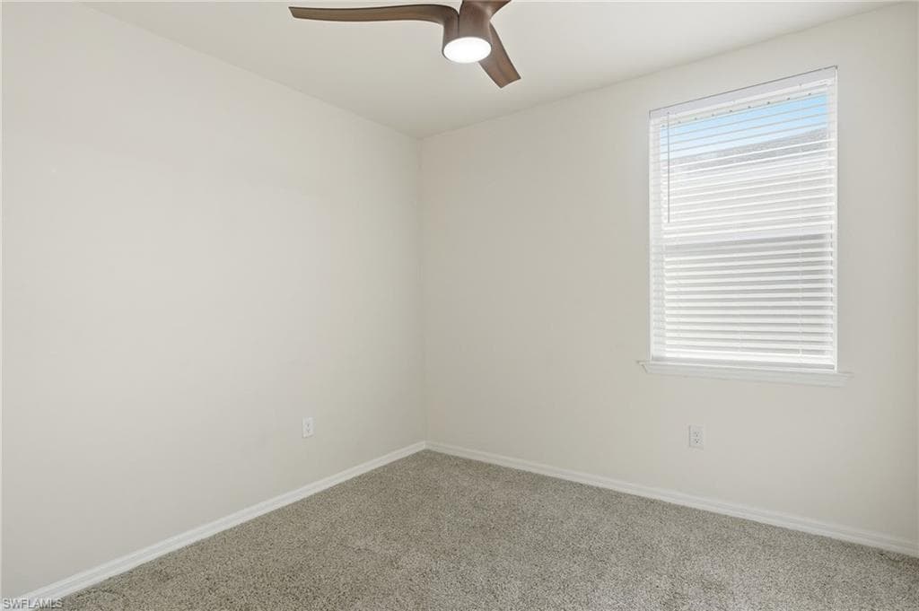Room featuring light gray carpet, white painted walls, and a single window with horizontal blinds