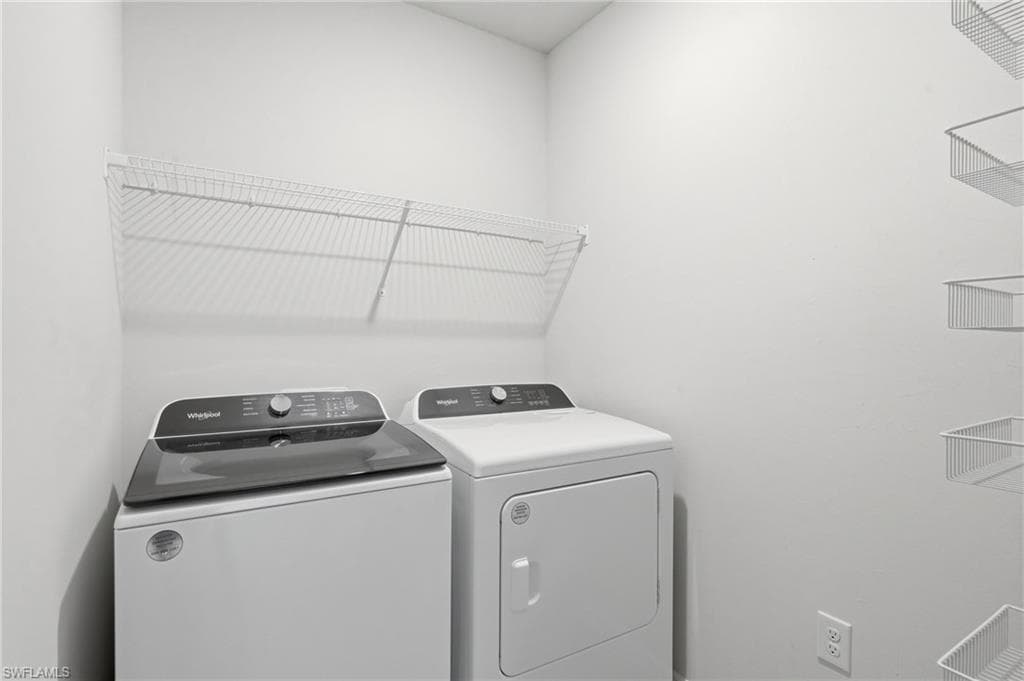 Dedicated laundry area featuring white walls and built-in wire shelving