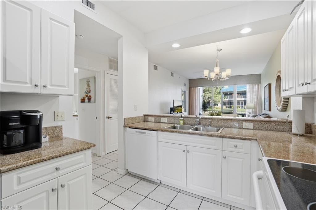 LARGE, SPACIOUS KITCHEN WITH SLEEK WHITE CABINETRY AND GRANITE COUNTERS..