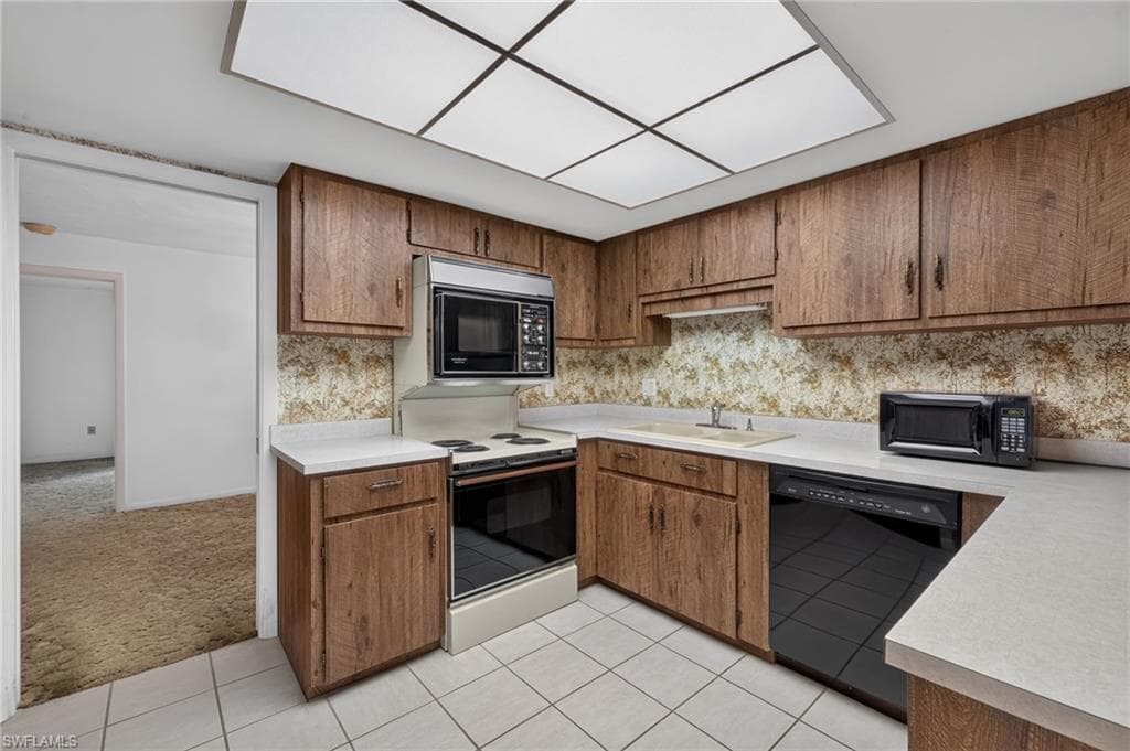 The Kitchen is the Center of the Home with a Range and Microwave from the 80's