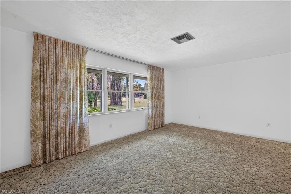 Actual Primary Bedroom featuring a Large Window that looks out onto the Beautiful Property
