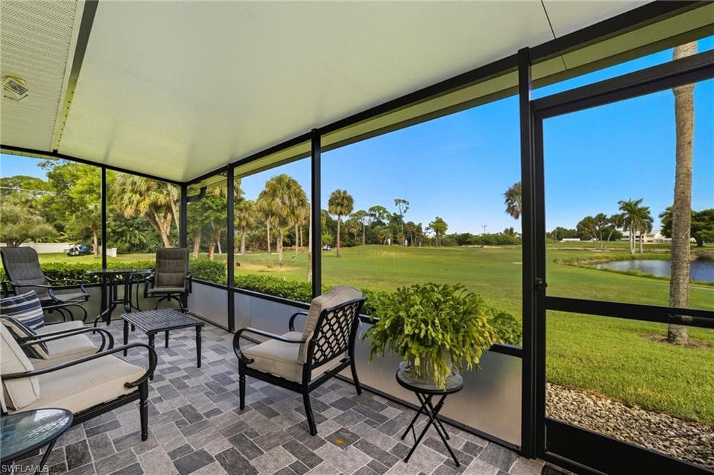 Screened lanai featuring a patterned tile floor, white ceiling, and black aluminum framing