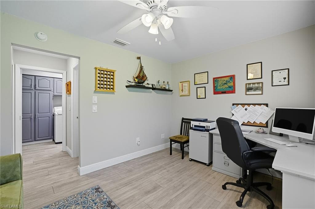 Versatile room featuring wood-finish flooring and a ceiling fan with light fixture