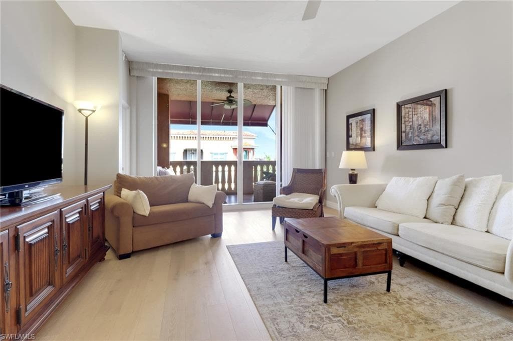 Living area featuring ceiling fan and light wood finished floors
