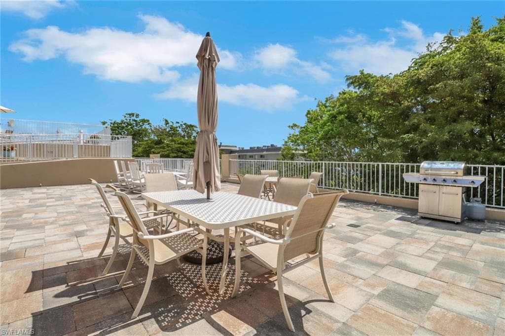 View of patio / terrace with a grill and outdoor dining space