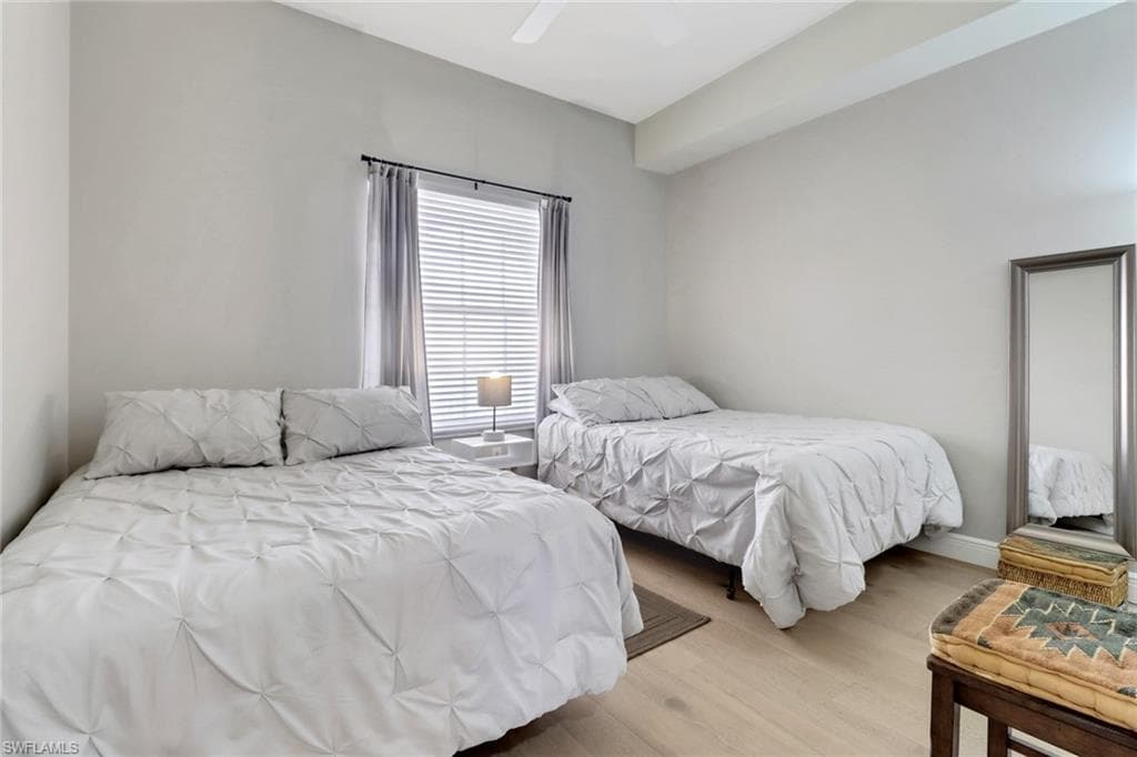 Bedroom with light wood finished floors and a ceiling fan