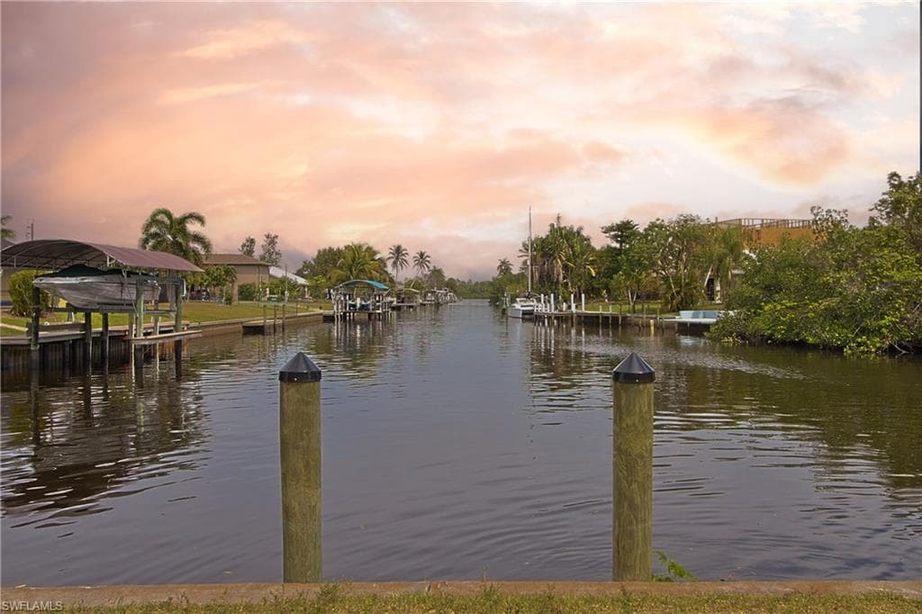 Waterfront canal featuring boat docks and lush tropical landscaping