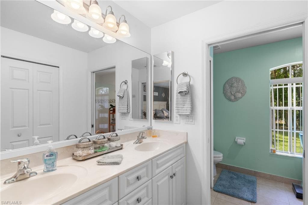 Double vanity with light-toned countertops and under-sink cabinetry