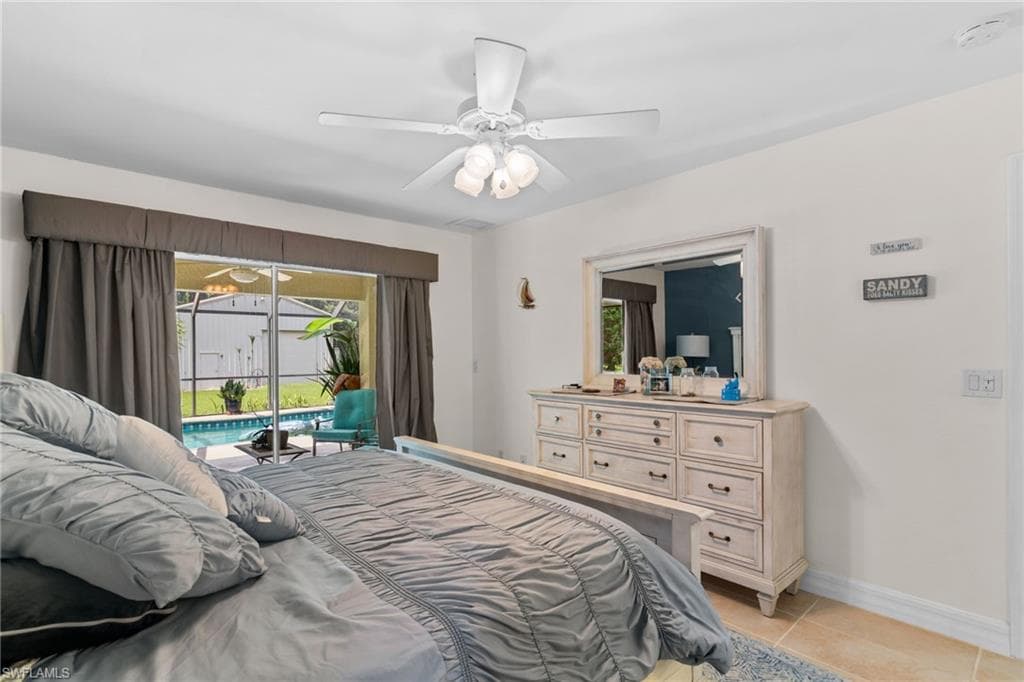Bedroom with sliding glass doors opening to an outdoor pool area