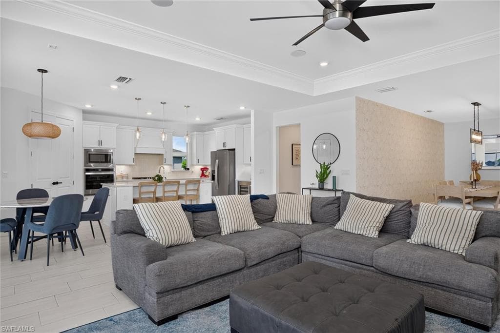 Gather with family and friends in the expansive great room, where the open layout, tray ceiling and abundant natural light create a warm and inviting atmosphere