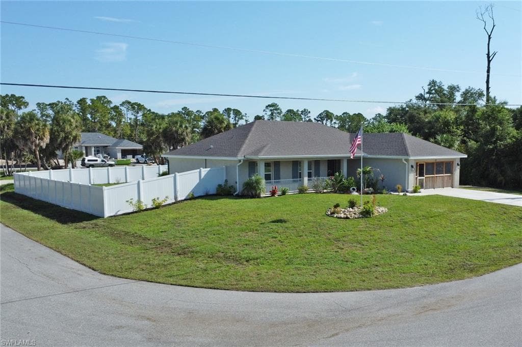 Single-story residence featuring a screen-enclosed garage, a covered front entry, and a well-maintained lawn