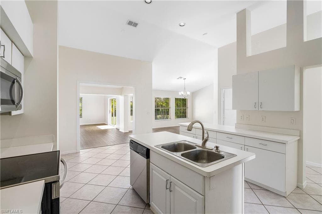 Bright kitchen featuring all stainless-steel appliances